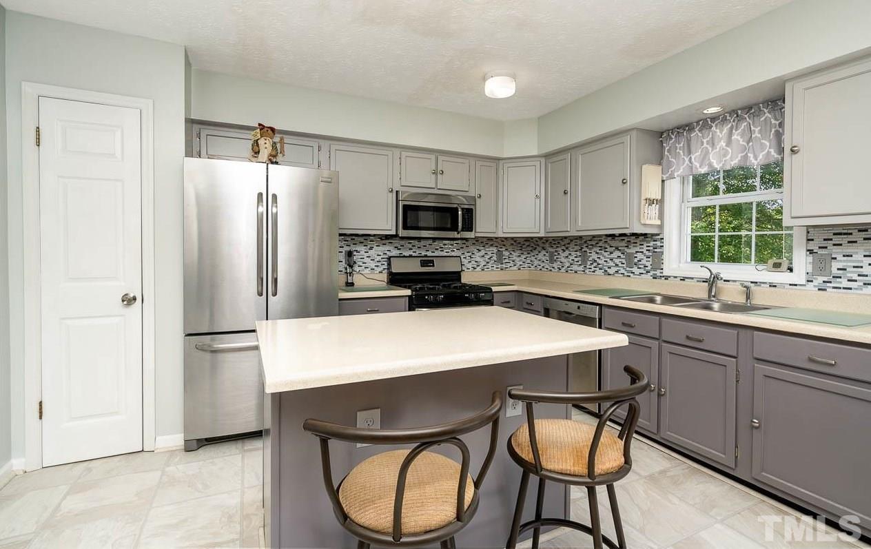 3255 Walters Road Creedmoor, NC 27522 - Photo 7 of 19 a kitchen with stainless steel appliances a refrigerator sink and cabinets