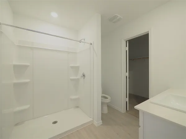 a bathroom with a shower and a toilet