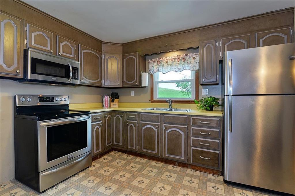 680 Dry Ridge Road West Alexander, PA 15376 - Photo 6 of 19 a kitchen with stainless steel appliances granite countertop a refrigerator a stove a sink and a microwave