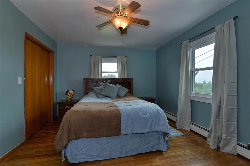680 Dry Ridge Road West Alexander, PA 15376 - Photo 8 of 19 a bedroom with a bed and a chandelier