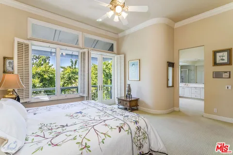 a bedroom with a large bed and a large window