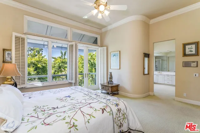 a bedroom with a large bed and a large window