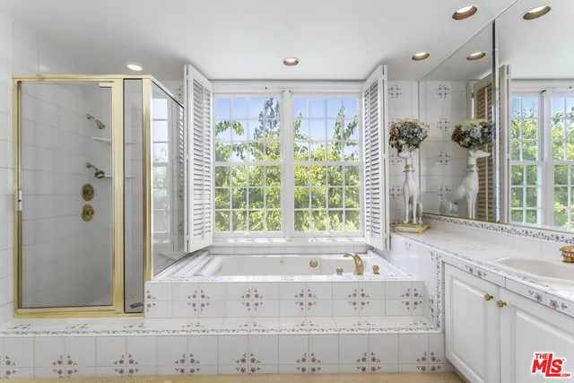 a view of bathroom with bathtub and shower