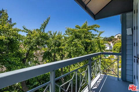 a view of a balcony with wooden fence
