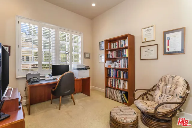 a view of a livingroom with workspace and a window