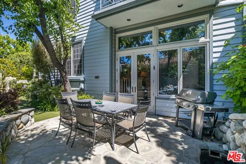 a view of a patio with table and chairs and potted plants