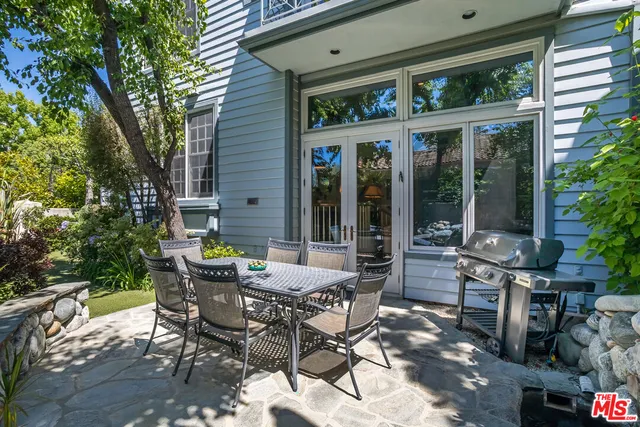 a view of a patio with table and chairs and potted plants