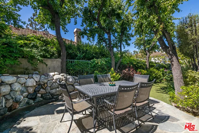 a view of a chairs and table in backyard of the house