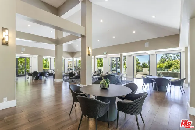 a living room with furniture and large windows