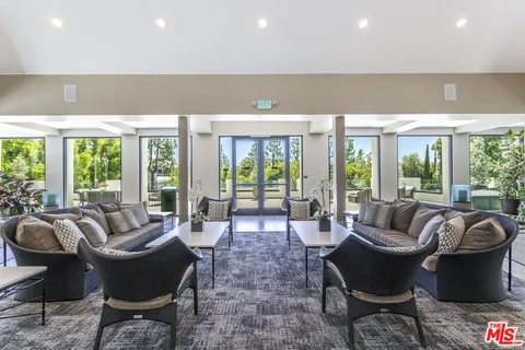 a view of a patio with couches table and chairs and potted plants