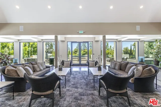 a view of a patio with couches table and chairs and potted plants