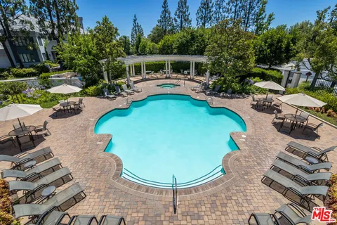 an outdoor space with swimming pool and furniture