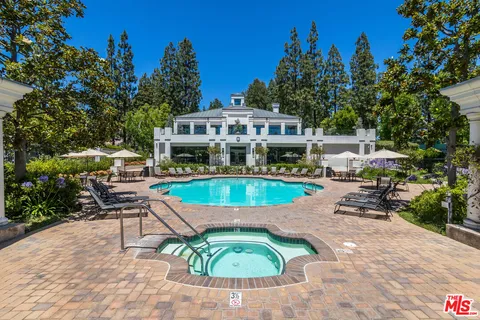 a view of swimming pool with a table and chairs