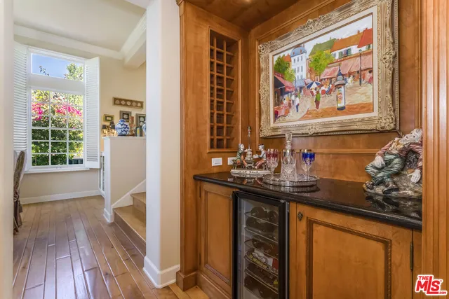 a view of a kitchen with a sink and wooden floor