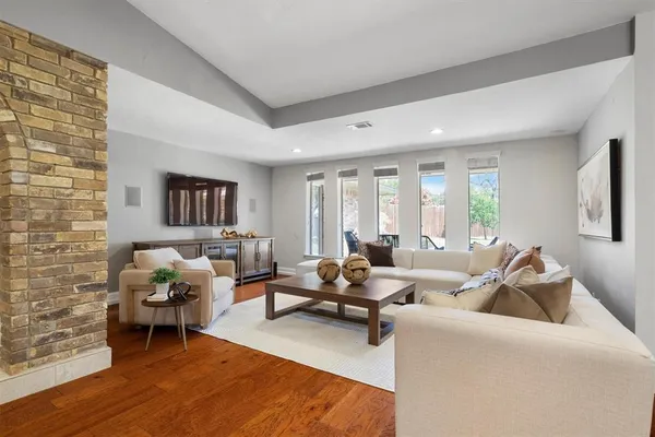a living room with furniture and wooden floor