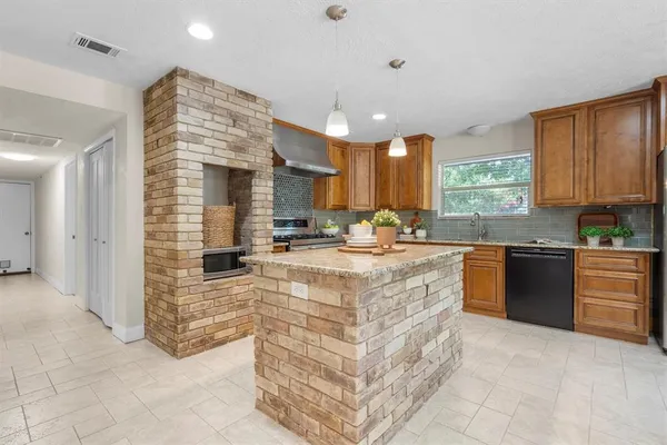 a kitchen with stainless steel appliances granite countertop a stove sink and cabinets
