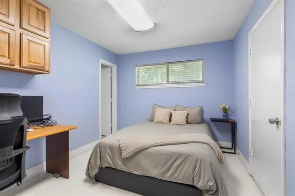 a bedroom with a bed and cabinets