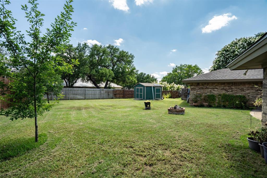2016 Pembrooke Place Denton, TX 76205 - Photo 34 of 40 a view of a house with a backyard and a slide