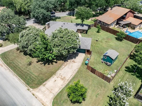 an aerial view of a house with a yard