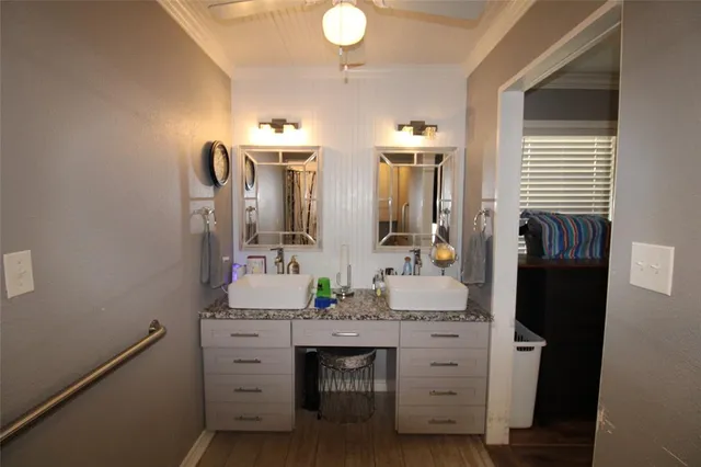 a bathroom with a double vanity sink and a mirror