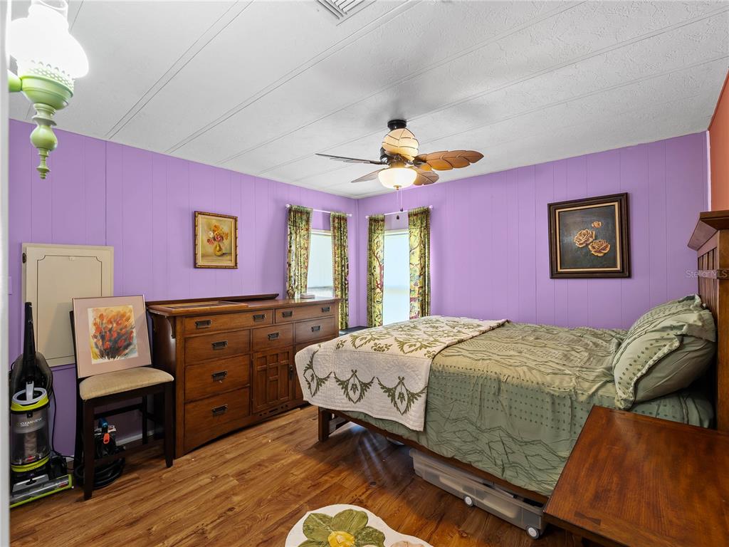 154 Rarotonga Road North Port, FL 34287 - Photo 11 of 47 a bedroom with a bed and a chandelier