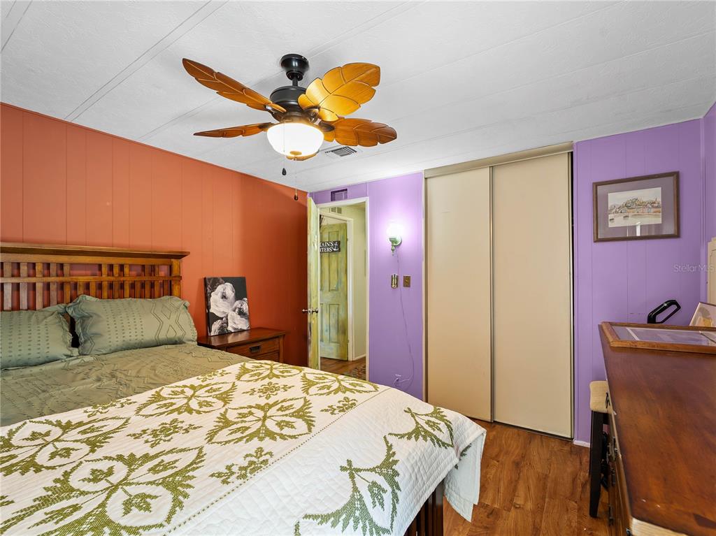 154 Rarotonga Road North Port, FL 34287 - Photo 13 of 47 a bedroom with a bed and wooden floor