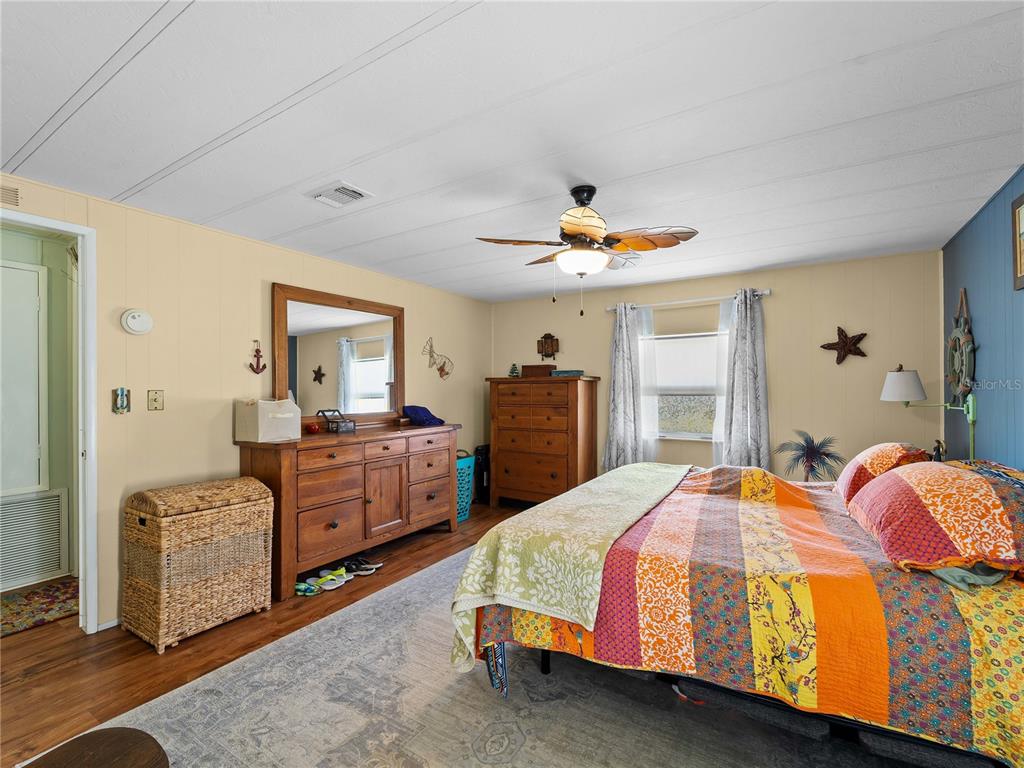 154 Rarotonga Road North Port, FL 34287 - Photo 14 of 47 a bedroom with a bed and a chandelier