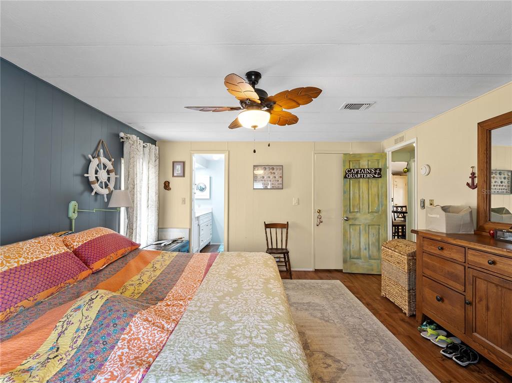 154 Rarotonga Road North Port, FL 34287 - Photo 15 of 47 a bedroom with a bed and a chandelier