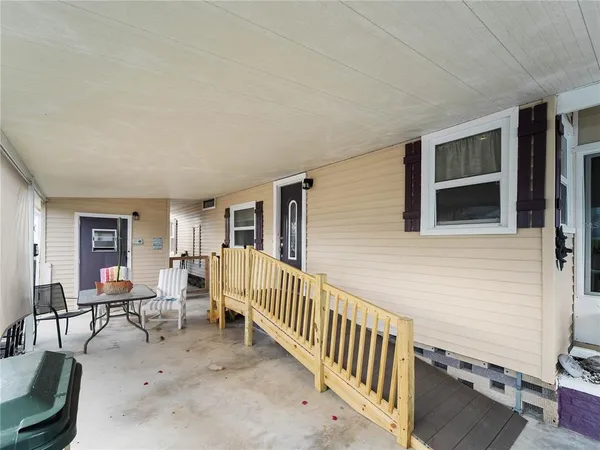 a view of a porch with wooden floor and stairs