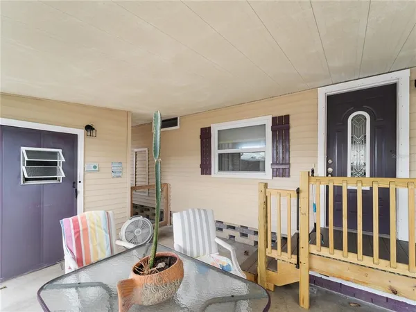 a backyard of a house with table and chairs