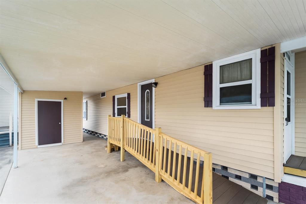 154 Rarotonga Road North Port, FL 34287 - Photo 24 of 47 a view of a porch with wooden floor and stairs