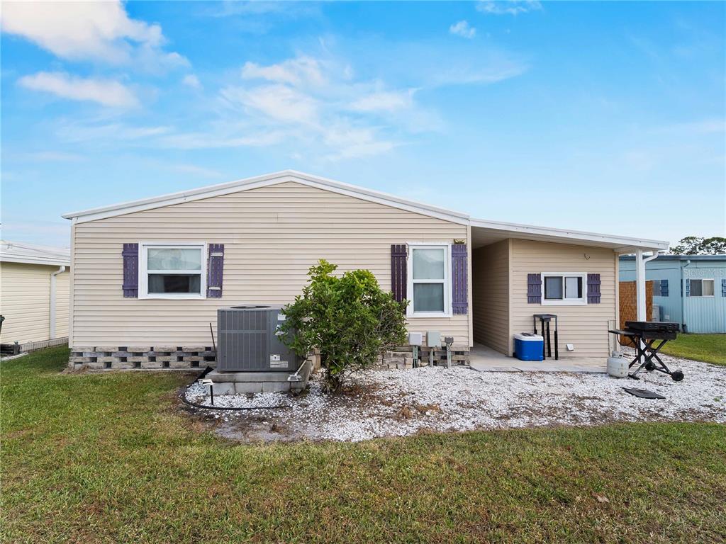 154 Rarotonga Road North Port, FL 34287 - Photo 25 of 47 a backyard of a house with table and chairs
