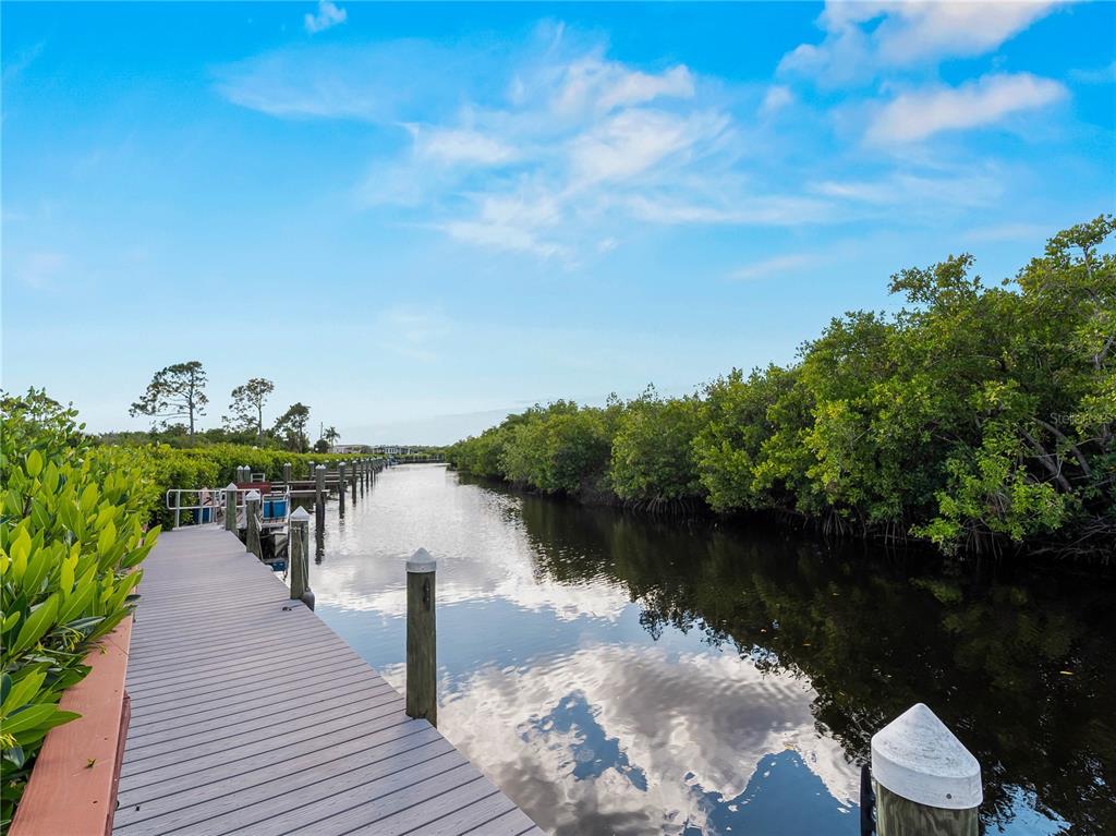 154 Rarotonga Road North Port, FL 34287 - Photo 33 of 47 a front view of a lake with boats and trees in the background