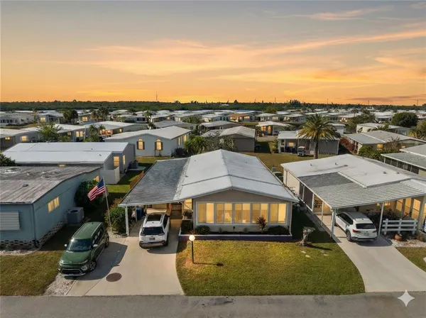 a car parked in front of house with a yard