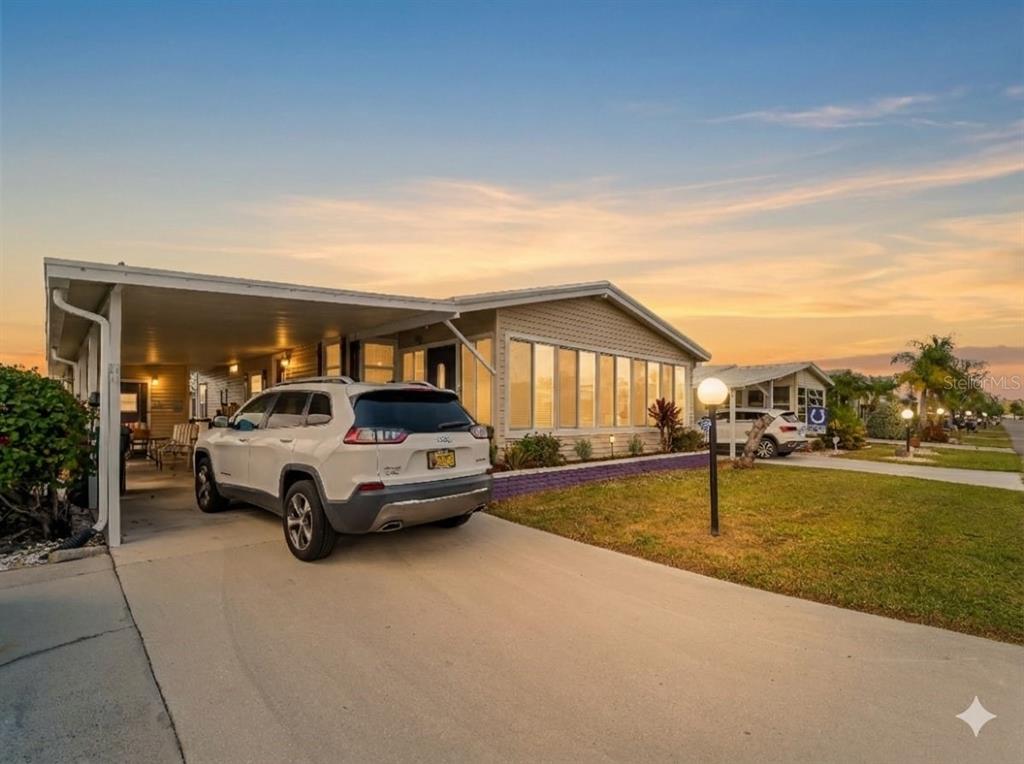 154 Rarotonga Road North Port, FL 34287 - Photo 47 of 47 a car parked in front of house with a yard