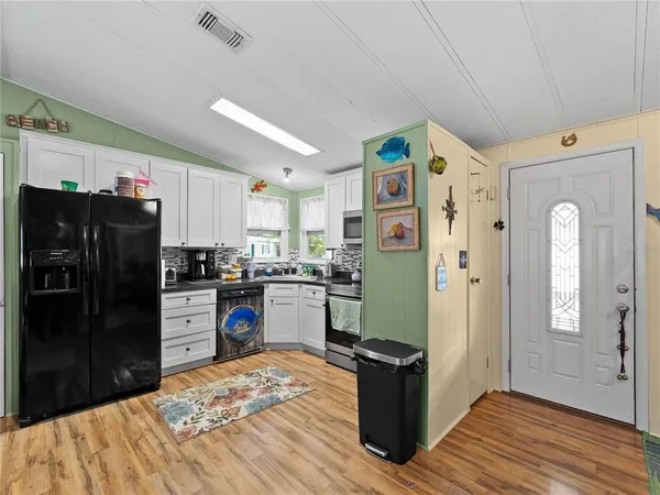 a kitchen with a refrigerator and cabinets