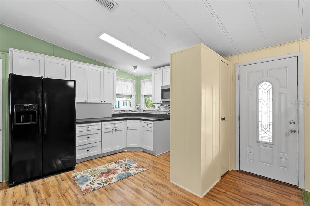 154 Rarotonga Road North Port, FL 34287 - Photo 8 of 47 a kitchen with a refrigerator and cabinets