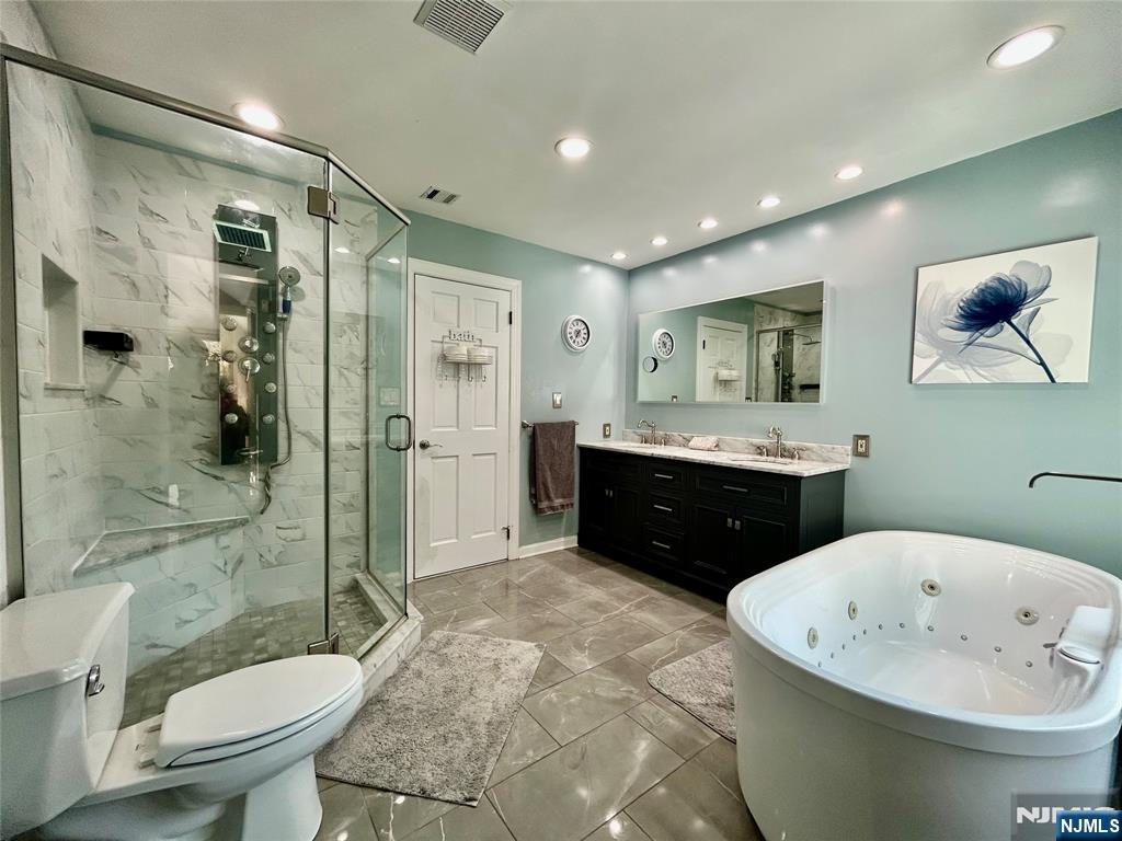 157 West Glen Road Denville, NJ 07834 - Photo 29 of 45 a bathroom with a double vanity sink toilet mirror and bathtub