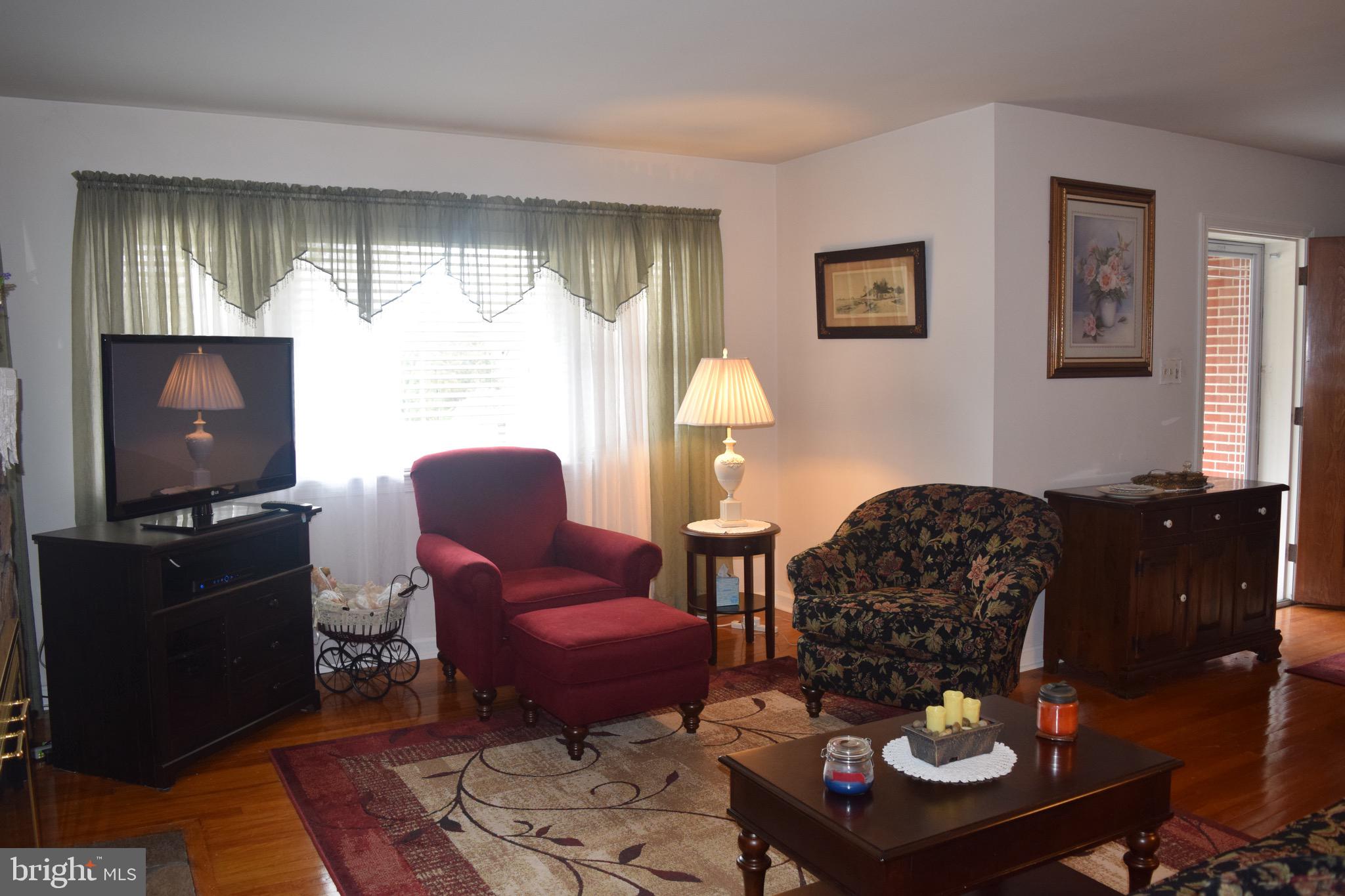 1413 Appleton Road Elkton, MD 21921 - Photo 8 of 24 Cozy living room with stone fireplace and hardwood
