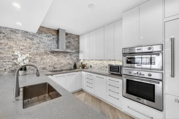 a kitchen with cabinets appliances and a sink