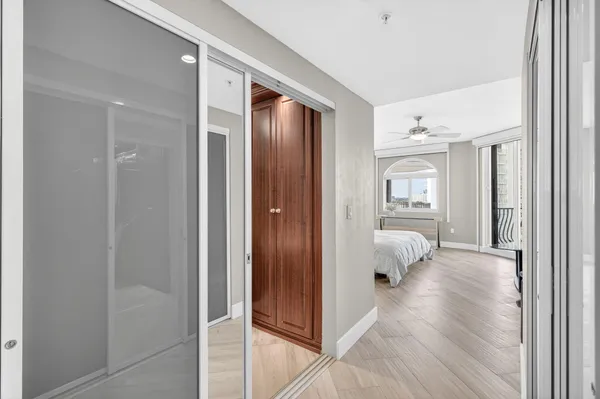 a bedroom with a bed and a chandelier