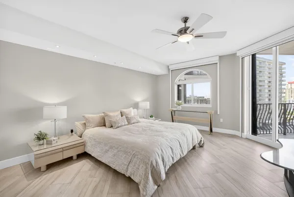 a spacious bedroom with a bed and a chandelier
