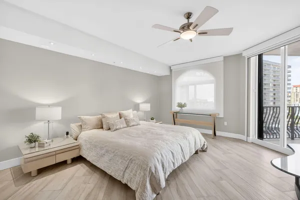 a bedroom with a bed and a large window