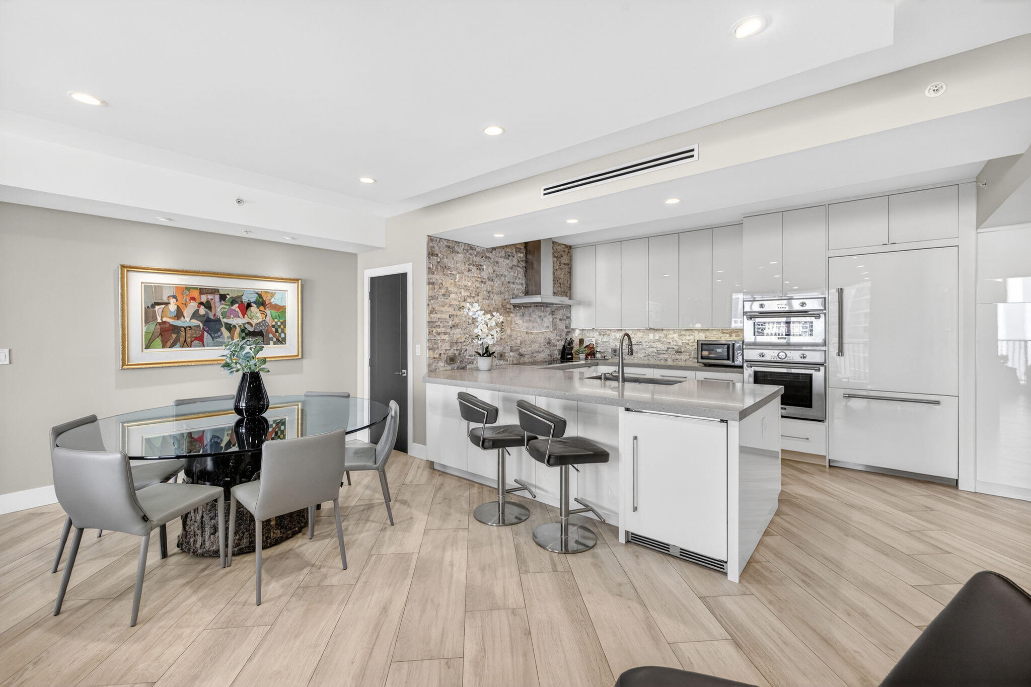 100 South Birch Road, Unit 803 Fort Lauderdale, FL 33316 - Photo 6 of 57 a living room with stainless steel appliances kitchen island granite countertop furniture a dining table and chairs