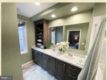 a living room with furniture and potted plants