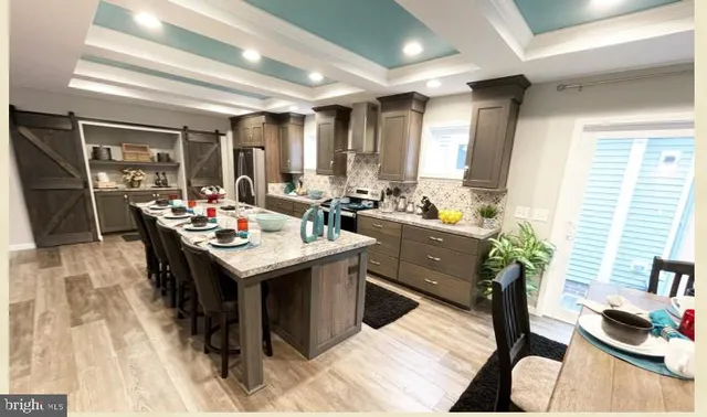 a kitchen with stainless steel appliances granite countertop a sink stove and cabinets