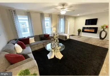 a living room with furniture and a wooden floor