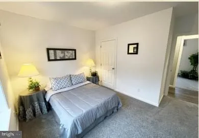 a bedroom with a bed and a wall painting