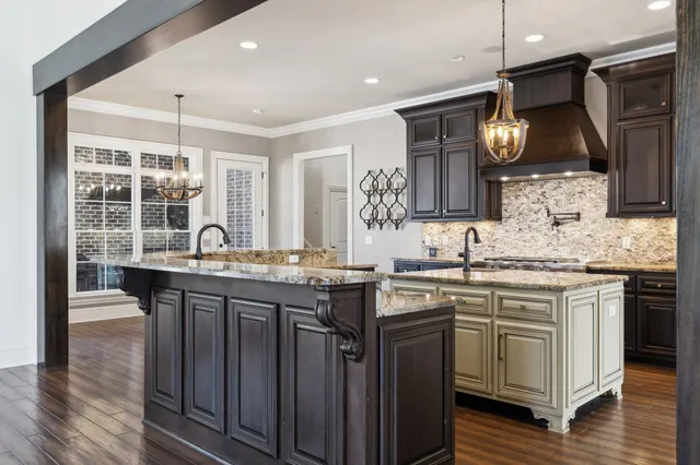 a kitchen with stainless steel appliances granite countertop a stove and a sink