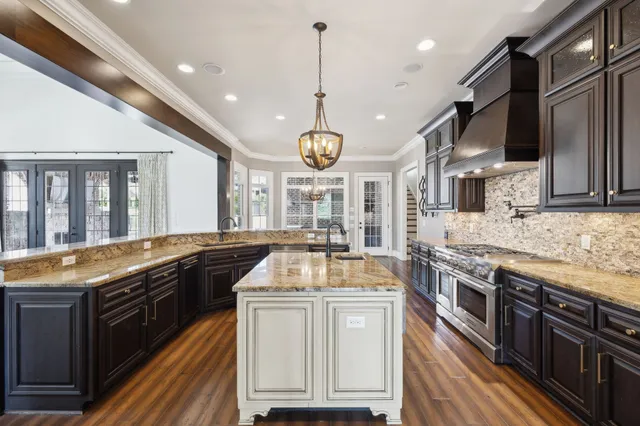 a kitchen with stainless steel appliances granite countertop a stove and a refrigerator